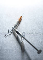 Vaccine pouring out of broken syringe - ABRF00807