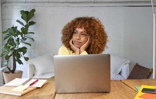 Young businesswoman day dreaming while working from home - VEGF03312