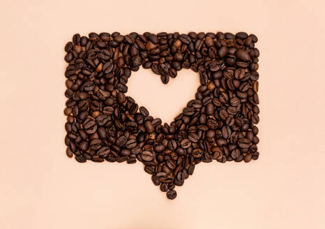 Geröstete Kaffeebohnen in Form eines Herzens in einer Online-Chatblase angeordnet - GEMF04460