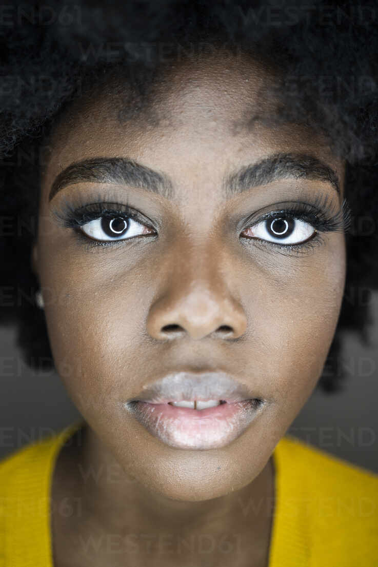 Close up of young woman face with circle flash reflection in eyes