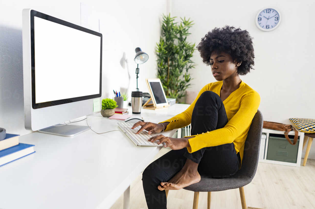 woman sitting at an office desk and working with a computer