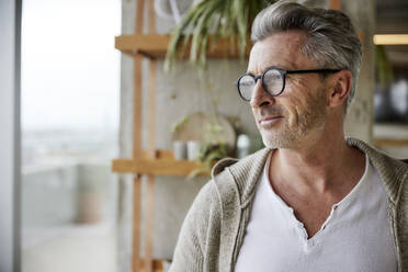 Mature man wearing eyeglasses looking away - FMKF06929