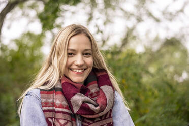 Blond woman with scarf in park during autumn - BFRF02329