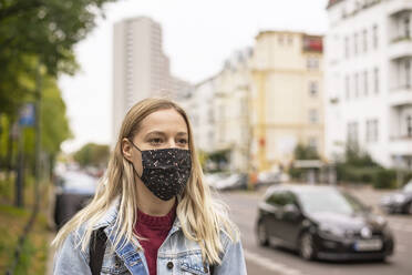 Young woman with protective face mask in city - BFRF02349