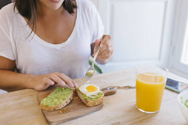 Close-up view of unrecognizable woman preparing some breakfast's toast - ADSF19240