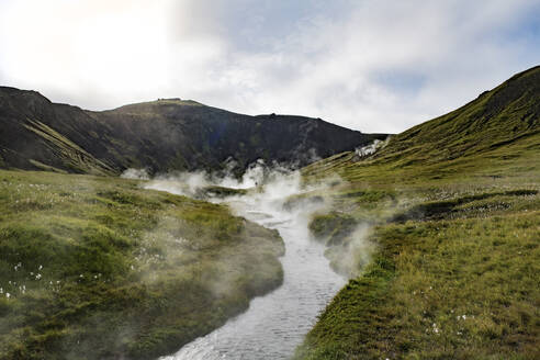 Der Thermalfluss Reykjadalur fließt durch ein Tal in Island - NEKF00048