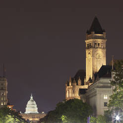 USA, Washington DC, Tower of Old Post Office at night with United States Capitol in background - AHF00248