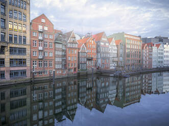 Germany, Hamburg, Row of townhouses reflecting in Nikolaifleet canal - RJF00834