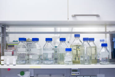 Liquid solution bottles on shelf in laboratory - BMOF00480