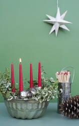 Studio shot of DIY Advent decorations including candles, twigs, pine cone, matches and baking pan - GISF00715