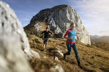 Sportsman and woman running on Saulingspitze mountain at Bavaria, Germany - MALF00333