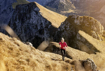 Female athlete running on Aggenstein mountain at Bavaria, Germany - MALF00337