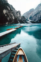 From above wooden quay on amazing scenery of lake with turquoise water in mountains on foggy day - ADSF19366