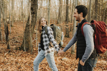 Young couple holding hands during autumn hike - SMSF00476