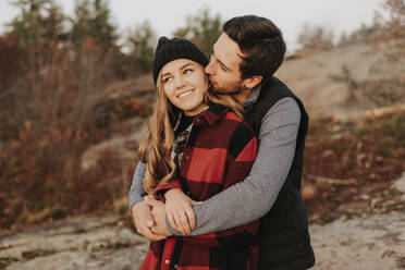 Young couple embracing during autumn hike - SMSF00526