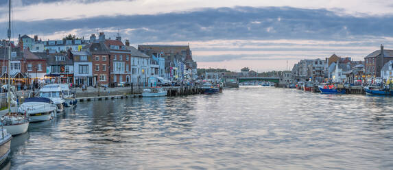 View of boats in the Old Harbour and quayside houses at dusk, Weymouth, Dorset, England, United Kingdom, Europe - RHPLF18627