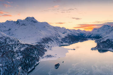 Aerial view of sunset over Lake Sils and Piz Da La Margna covered with snow, Maloja Pass, Engadine, Graubunden canton, Swiss Alps, Switzerland, Europe - RHPLF18948