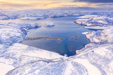 Aerial view of Norwegian County Road 98 along snowy mountains above Laksefjorden, Lebesby, Kunes, Troms og Finnmark, Arctic, Norway, Scandinavia, Europe - RHPLF18973