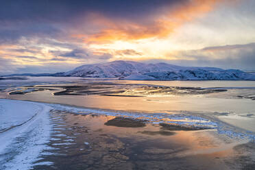 Sunset over the snow capped mountains and frozen sea in the pristine Tanamunningen Nature Reserve, Leirpollen, Finnmark, Arctic, Norway, Scandinavia, Europe - RHPLF18977