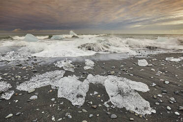 Melting glacial ice, carved from the Vatnajokull icecap, on the beach at Jokulsarlon, on the south coast of Iceland, Polar Regions - RHPLF19011