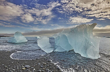 Melting glacial ice, carved from the Vatnajokull icecap, on the beach at Jokulsarlon, on the south coast of Iceland, Polar Regions - RHPLF19014