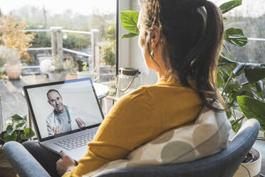 Woman consulting with doctor during video call on laptop - UUF22319