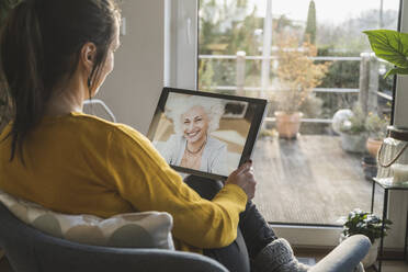 Zwei Frauen unterhalten sich während eines Videoanrufs auf einem digitalen Tablet - UUF22323