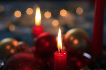 Red burning advent candles and Christmas baubles - JTF01759