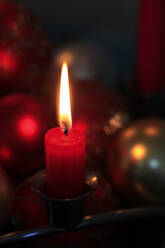 Red burning advent candle and Christmas baubles - JTF01760