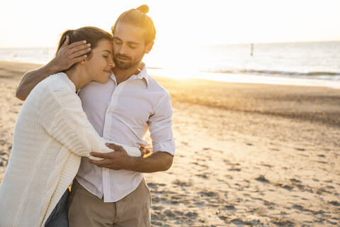 Romantic young couple at beach during vacation stock photo