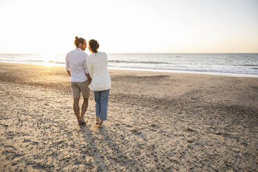 Young couple spending leisure time at beach during vacation - UUF22372