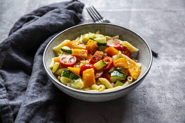 Bowl of vegan pasta with pumpkin, tomatoes and zucchini - SARF04647