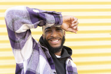 Young male rapper wearing nose ring against corrugated iron - JCCMF00342