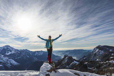 Mature male hiker with arms outstretched standing on mountain, Orobic alps, Lecco, Italy - MCVF00702