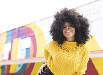 Young woman smiling while standing outdoors - JCCMF00388