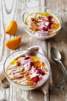 Two bowls of curd cheese raspberries and persimmons - EVGF03862