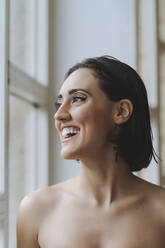 Close-up of happy topless young woman looking away in ballet studio - MTBF00823