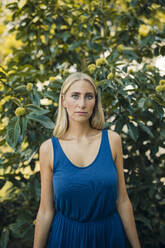 Young woman against plant in park - GUSF04867