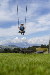 Little girl playing on swing - DIGF13973