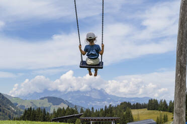Little girl playing on swing - DIGF13974