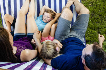 Family relaxing on hammock during weekend - AWAF00022