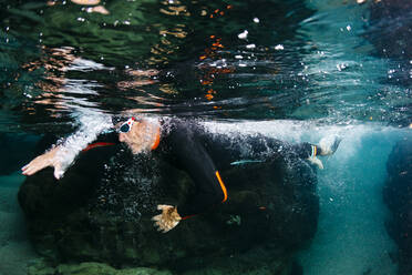 Underwater view of man diving in sea - JRFF04979