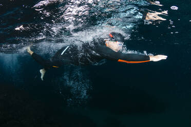 Underwater view of man diving in sea - JRFF04984