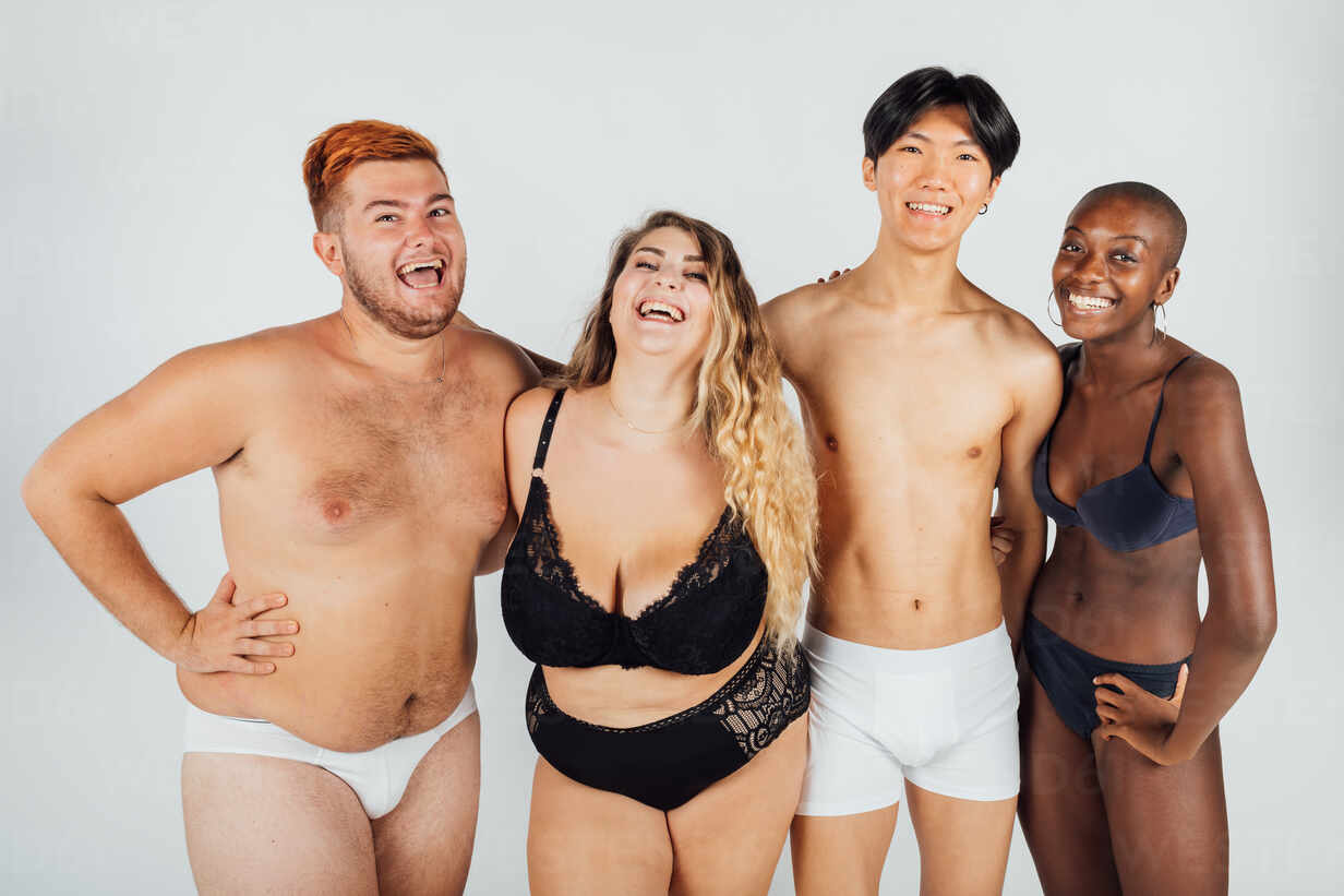 Friends laughing, wearing underwear stock photo