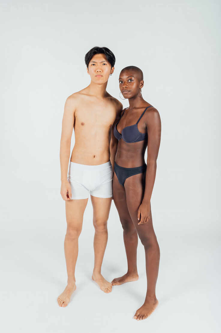 Young couple wearing underwear, full length stock photo - OFFSET