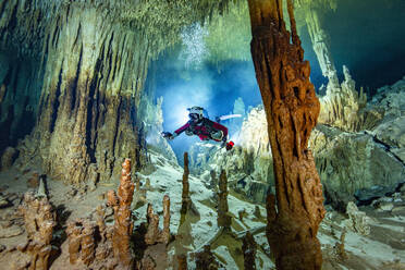 Male cave diver exploring in water, Cenote Zacil-Ha, Quintana Roo, Mexico - YRF00233