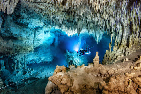 Male diver swimming in underwater, Cenote Uku Cusam, Quintana Roo, Mexico - YRF00238