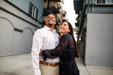 Late Forties Couple Laughing Standing in Alley in San Diego - CAVF91474