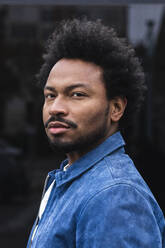 Close-up portrait of serious stylish man with afro hair - PNAF00467