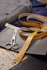 Scissors and tape measure in tailors boutique - AODF00165